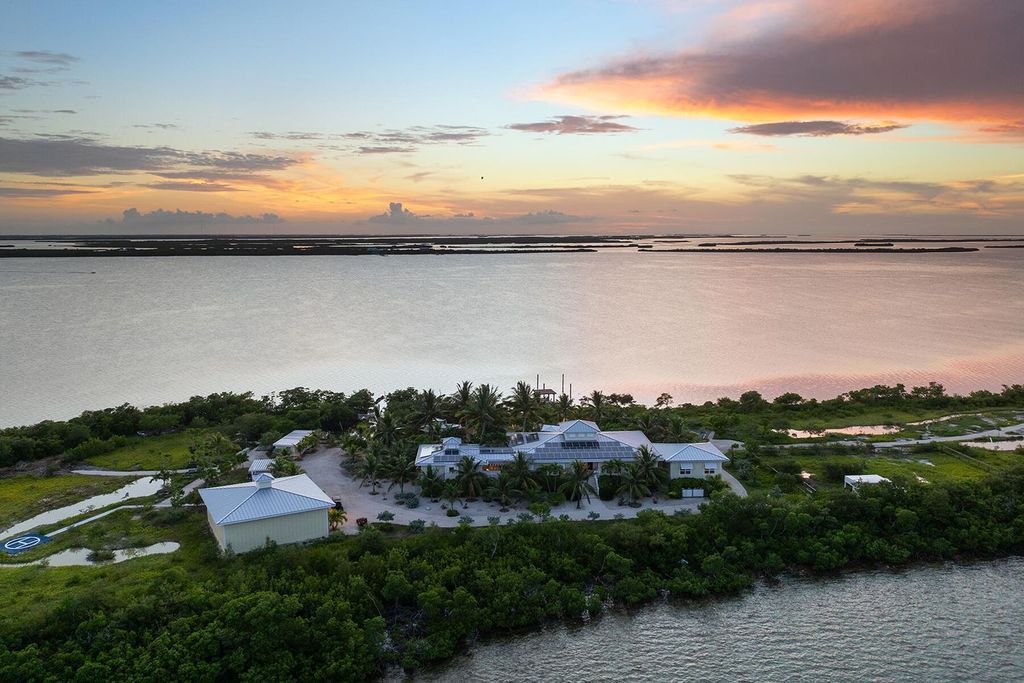 Seeking a one-of-a-kind escape? Howell Key, a turnkey 9.69-acre island paradise, awaits! This off-grid oasis boasts a 5-bedroom immaculate home, saltwater pool, guest house, helipad. Direct ocean access, proximity to Looe Key Sanctuary, and a second ROGO-exempt permit for your dream home make this the ultimate investment opportunity. Live your island dream or create an unforgettable vacation rental experience.