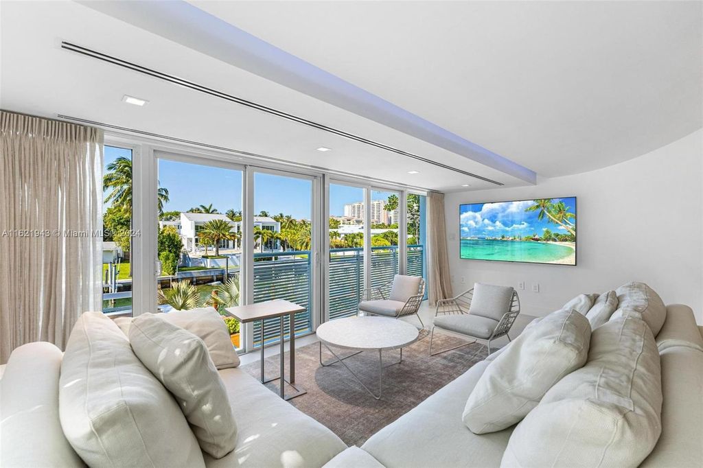 Immerse yourself in unparalleled luxury living in this stunning, completely renovated Key Biscayne waterfront home. Indulge in breathtaking canal views, a contemporary design, a private oasis, and top-of-the-line amenities, including a gym, home theater, summer kitchen, and boat lift. This 4-bedroom (easily convertible to 5) estate offers the ultimate in waterfront living.