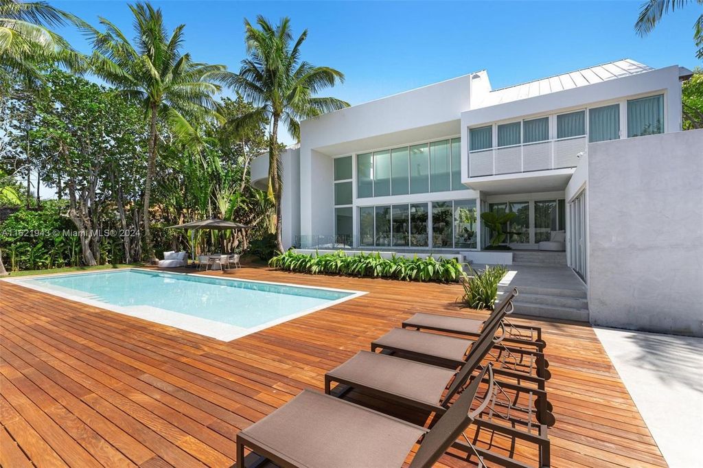 Immerse yourself in unparalleled luxury living in this stunning, completely renovated Key Biscayne waterfront home. Indulge in breathtaking canal views, a contemporary design, a private oasis, and top-of-the-line amenities, including a gym, home theater, summer kitchen, and boat lift. This 4-bedroom (easily convertible to 5) estate offers the ultimate in waterfront living.