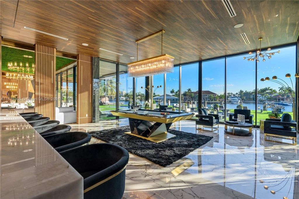 Live the ultimate Fort Lauderdale lifestyle in this 11,000+ square feet waterfront mansion by Dov Stark. Featuring deep water frontage, 5 beds, 11 baths, theater, gym, and more!