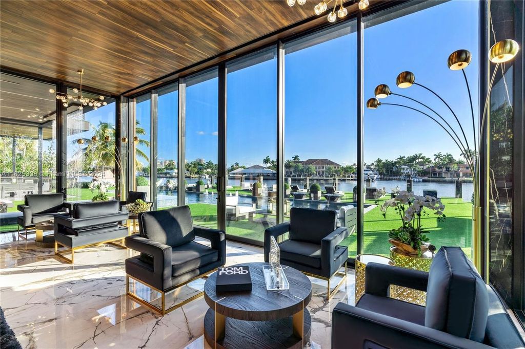 Live the ultimate Fort Lauderdale lifestyle in this 11,000+ square feet waterfront mansion by Dov Stark. Featuring deep water frontage, 5 beds, 11 baths, theater, gym, and more!