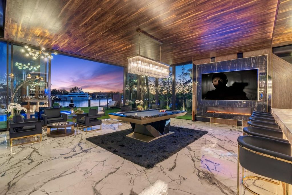 Live the ultimate Fort Lauderdale lifestyle in this 11,000+ square feet waterfront mansion by Dov Stark. Featuring deep water frontage, 5 beds, 11 baths, theater, gym, and more!