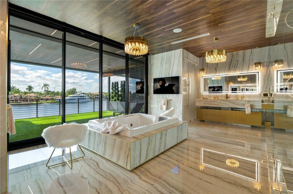 Live the ultimate Fort Lauderdale lifestyle in this 11,000+ square feet waterfront mansion by Dov Stark. Featuring deep water frontage, 5 beds, 11 baths, theater, gym, and more!