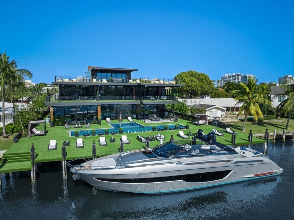 Live the ultimate Fort Lauderdale lifestyle in this 11,000+ square feet waterfront mansion by Dov Stark. Featuring deep water frontage, 5 beds, 11 baths, theater, gym, and more!