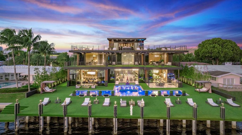 Live the ultimate Fort Lauderdale lifestyle in this 11,000+ square feet waterfront mansion by Dov Stark. Featuring deep water frontage, 5 beds, 11 baths, theater, gym, and more!