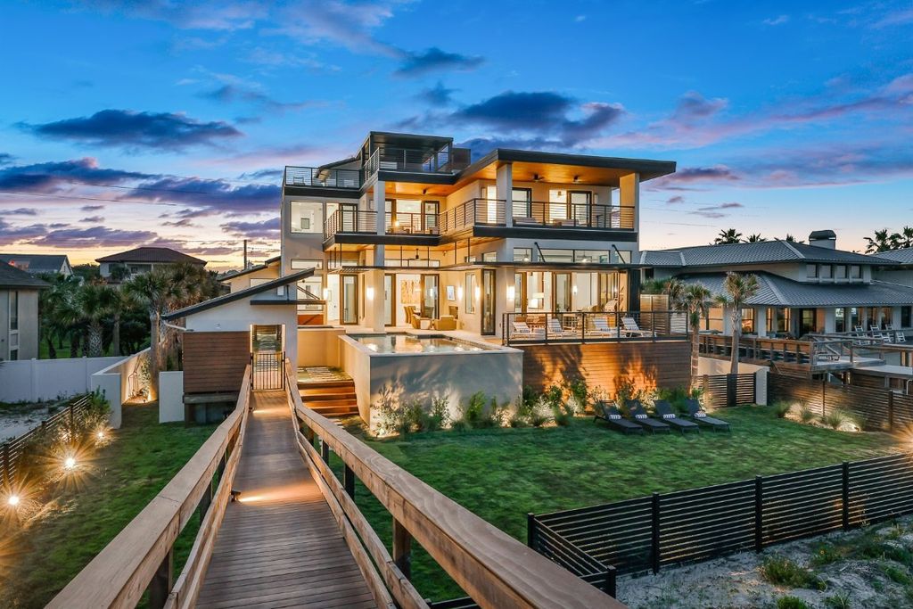 Immerse yourself in unparalleled luxury at this beachfront masterpiece on Amelia Island. This 6 bed, 8 bath custom estate boasts John Cotner design, commercial-grade construction, chef's kitchen, infinity pool and spa, and private guest house. Experience the epitome of coastal living.