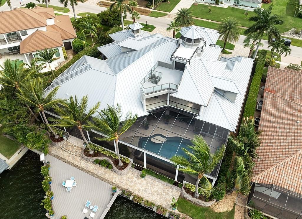 Never-before-listed masterpiece! This 7,100+ square feet estate boasts waterfront views, infinity pool, gourmet kitchen, and more! Perfect for entertaining with multiple living areas and a bonus room. Must-see in South Florida!