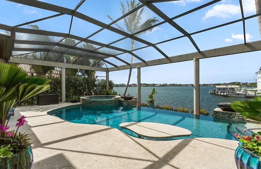 Never-before-listed masterpiece! This 7,100+ square feet estate boasts waterfront views, infinity pool, gourmet kitchen, and more! Perfect for entertaining with multiple living areas and a bonus room. Must-see in South Florida!