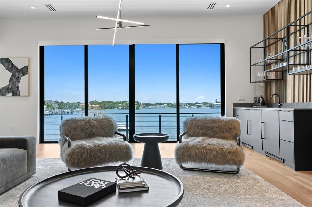 Rarely available NEW CONSTRUCTION! Live the dream in this 6-bedroom, 5.5-bath bayfront masterpiece. Sweeping water views, infinity pool, custom finishes, movie theater, wine cellar, and more in a sought-after school district. Available furnished.