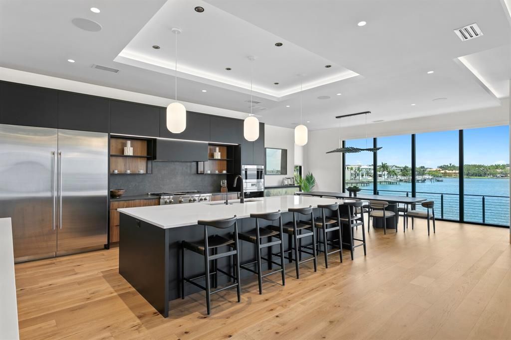 Rarely available NEW CONSTRUCTION! Live the dream in this 6-bedroom, 5.5-bath bayfront masterpiece. Sweeping water views, infinity pool, custom finishes, movie theater, wine cellar, and more in a sought-after school district. Available furnished.