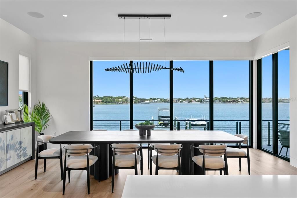 Rarely available NEW CONSTRUCTION! Live the dream in this 6-bedroom, 5.5-bath bayfront masterpiece. Sweeping water views, infinity pool, custom finishes, movie theater, wine cellar, and more in a sought-after school district. Available furnished.