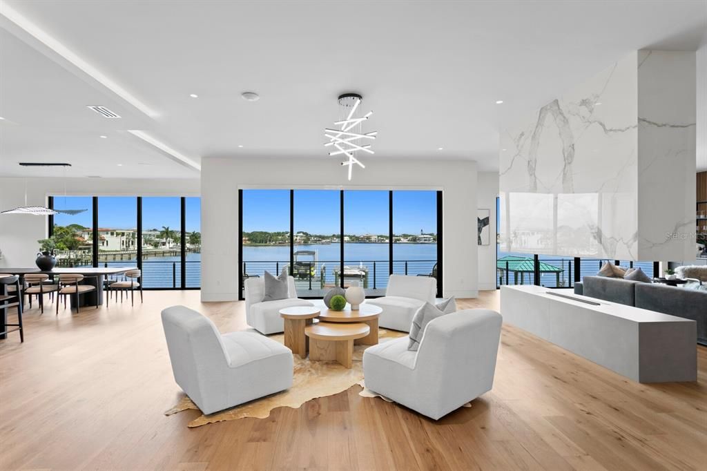 Rarely available NEW CONSTRUCTION! Live the dream in this 6-bedroom, 5.5-bath bayfront masterpiece. Sweeping water views, infinity pool, custom finishes, movie theater, wine cellar, and more in a sought-after school district. Available furnished.