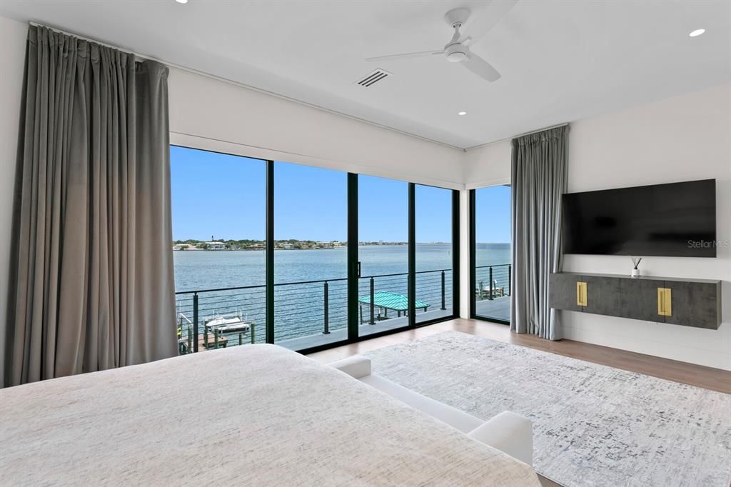 Rarely available NEW CONSTRUCTION! Live the dream in this 6-bedroom, 5.5-bath bayfront masterpiece. Sweeping water views, infinity pool, custom finishes, movie theater, wine cellar, and more in a sought-after school district. Available furnished.