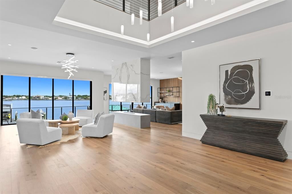 Rarely available NEW CONSTRUCTION! Live the dream in this 6-bedroom, 5.5-bath bayfront masterpiece. Sweeping water views, infinity pool, custom finishes, movie theater, wine cellar, and more in a sought-after school district. Available furnished.