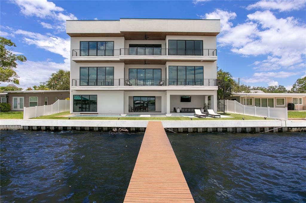 Rarely available NEW CONSTRUCTION! Live the dream in this 6-bedroom, 5.5-bath bayfront masterpiece. Sweeping water views, infinity pool, custom finishes, movie theater, wine cellar, and more in a sought-after school district. Available furnished.