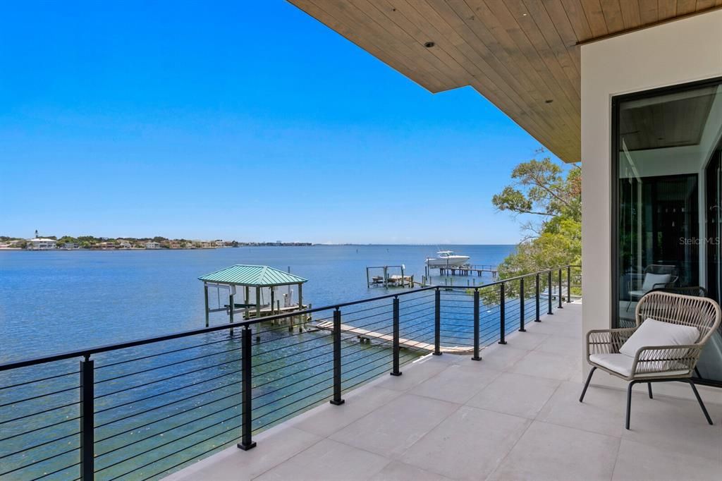 Rarely available NEW CONSTRUCTION! Live the dream in this 6-bedroom, 5.5-bath bayfront masterpiece. Sweeping water views, infinity pool, custom finishes, movie theater, wine cellar, and more in a sought-after school district. Available furnished.