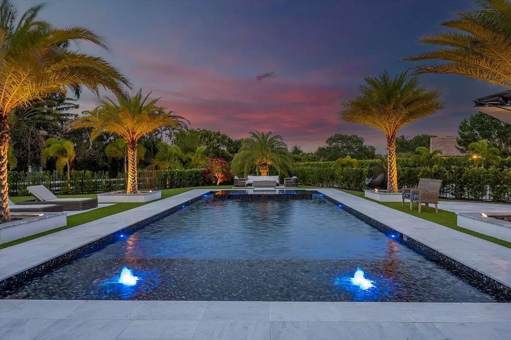 Experience unparalleled luxury in Wellington's finest aviation estate. Featuring a private hangar, resort-style pool, chef's kitchens, and home automation, this 7-bed, 8.5-bath estate redefines "dream home."