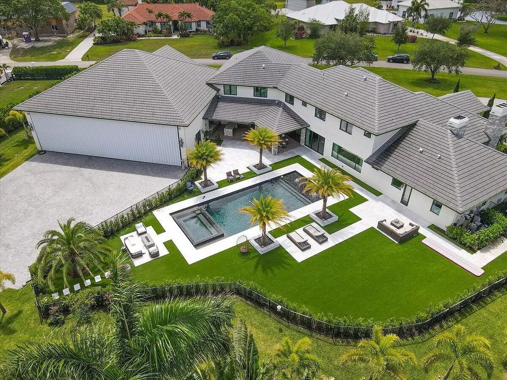 Experience unparalleled luxury in Wellington's finest aviation estate. Featuring a private hangar, resort-style pool, chef's kitchens, and home automation, this 7-bed, 8.5-bath estate redefines "dream home."